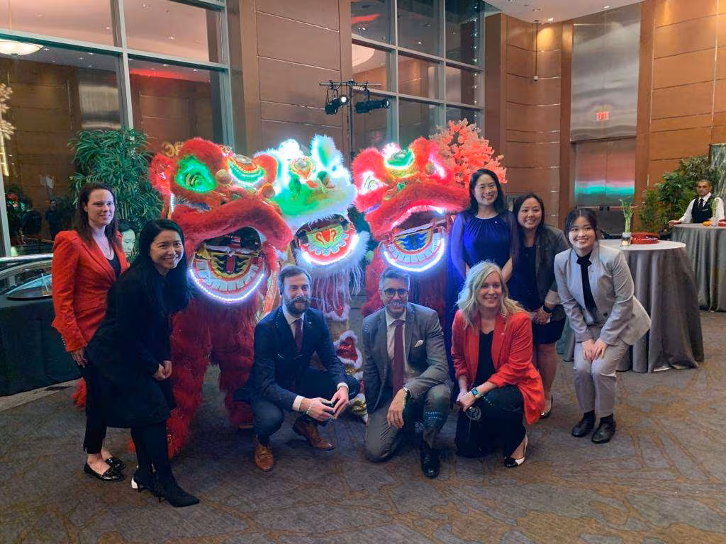 Guests posing with glowing LED lions at a gala