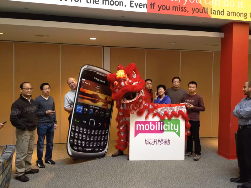 Red lion at a Mobilicity event next to a giant phone display