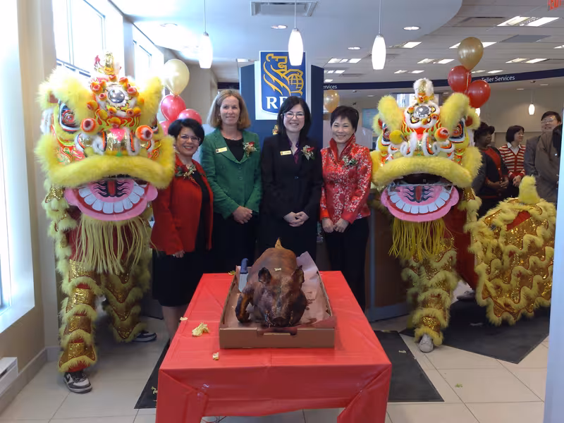 Yellow lions with RBC staff at a Chinese New Year celebration