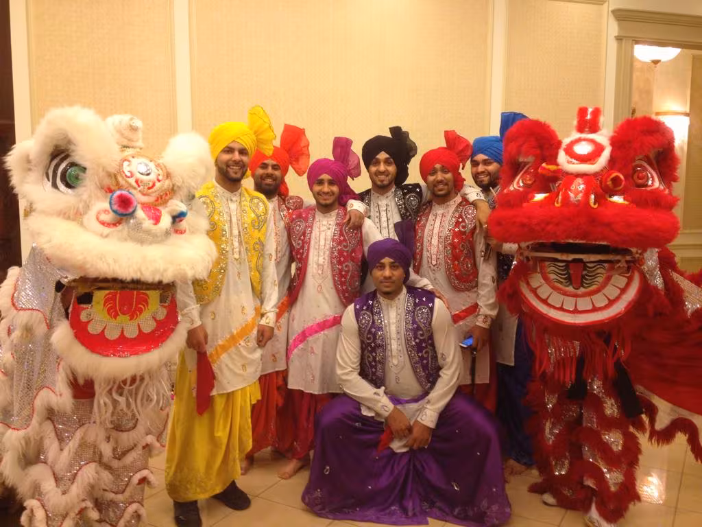 Guests in colourful turbans celebrating with lions